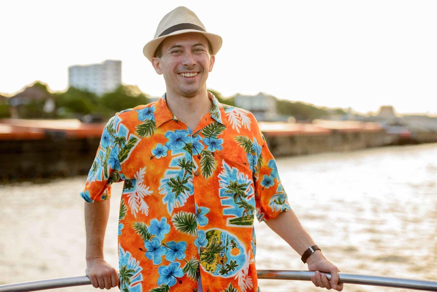 happy-young-handsome-tourist-man-at-pier-against-v-6HGMVEJ.jpg